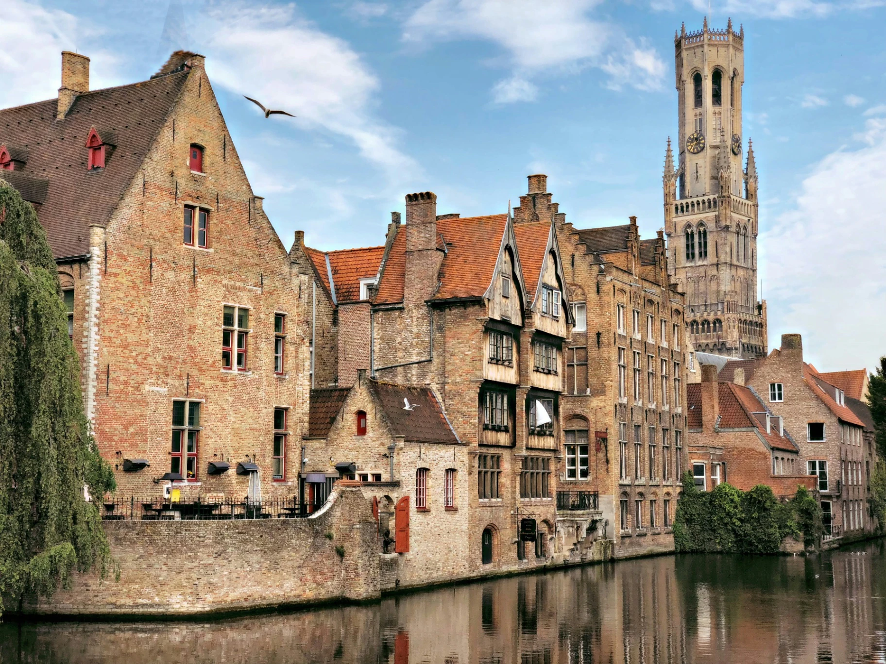 Canal view of Bruges Belgium with medieval buildings and historic bridge