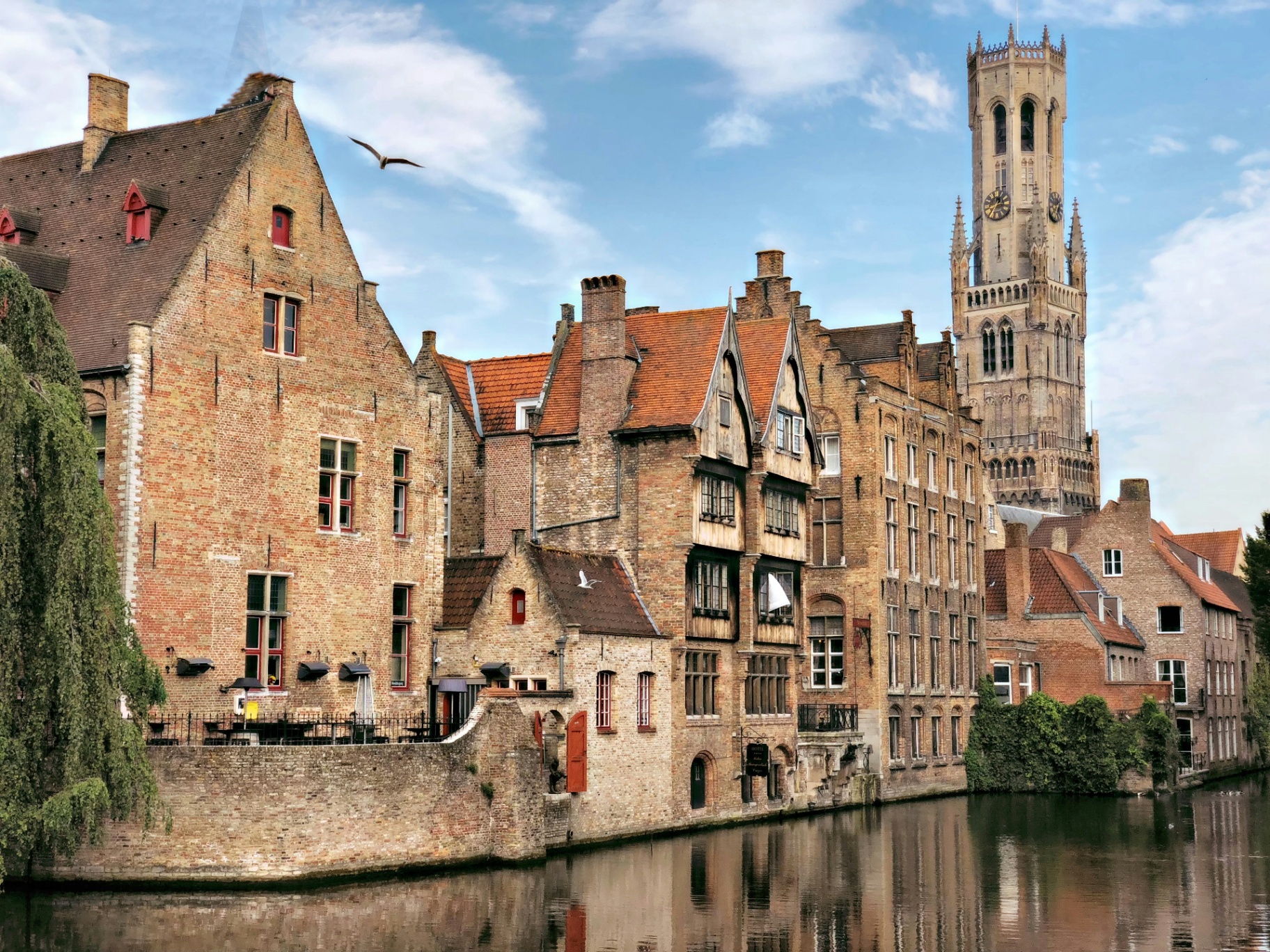 Canal view of Bruges Belgium with medieval buildings and historic bridge