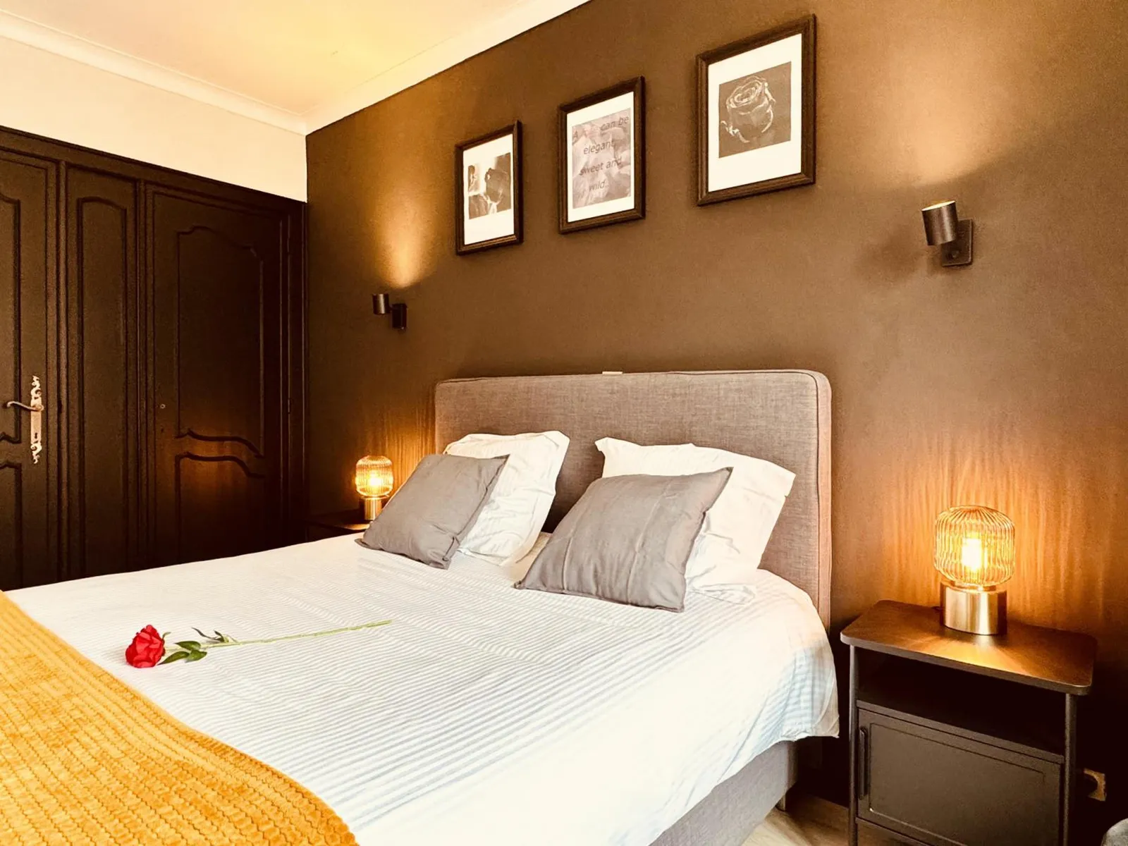 The bed with a red rose in The Cozy Double Room