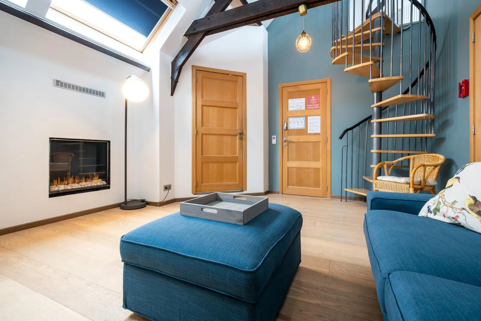 The electric fireplace and the spiral staircase in The Rose Tree