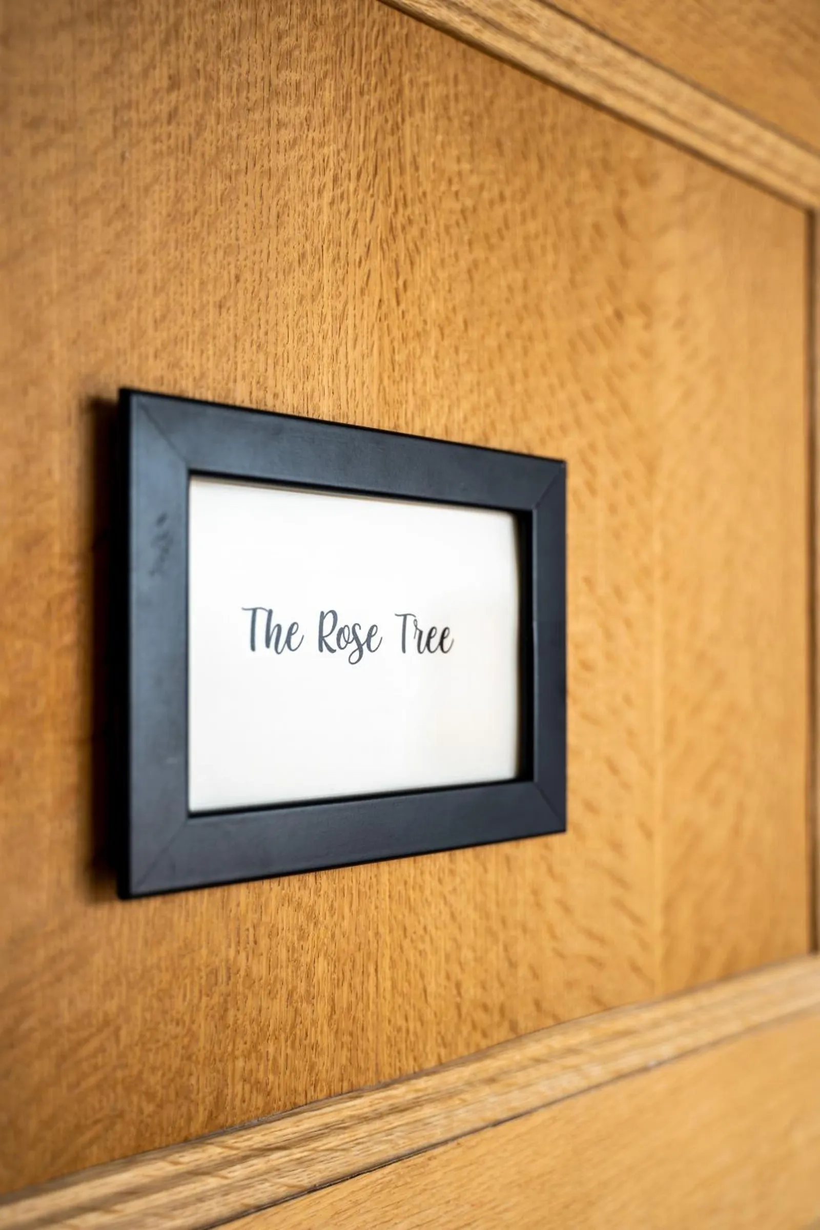 The name sign The Rose Tree on the door